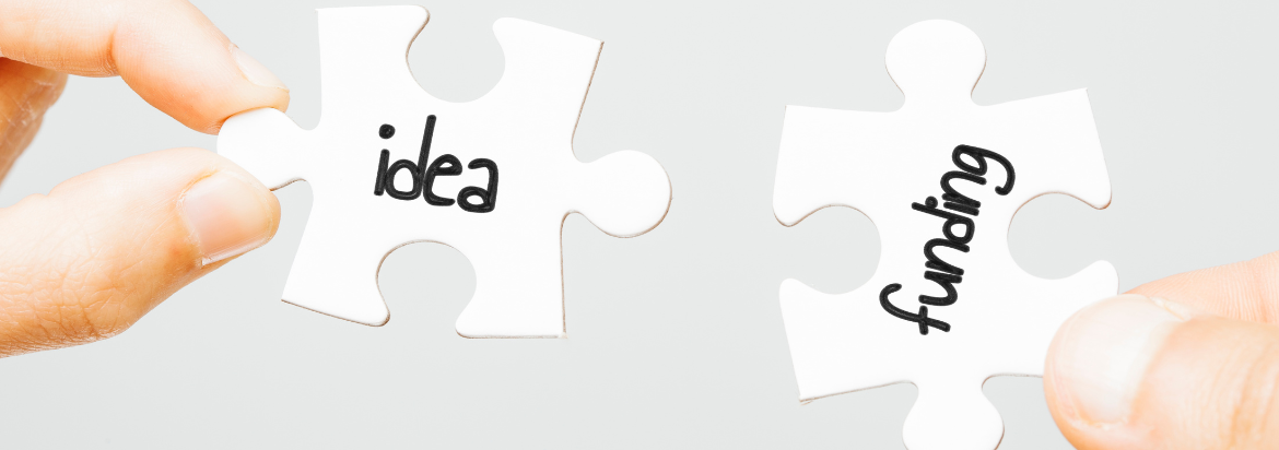 two hands holding two puzzle pieces that read "idea" and "funding"