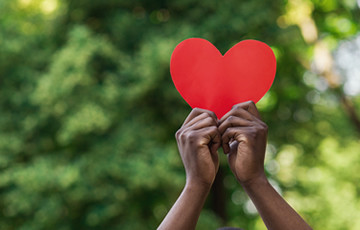 hands holding up a heart