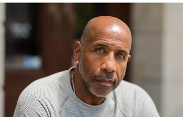 man in white t-shirt looking into camera